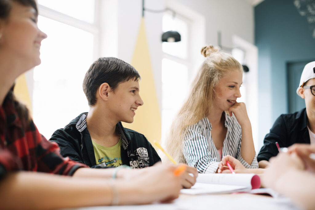 cheerful-students-having-talk-classroom